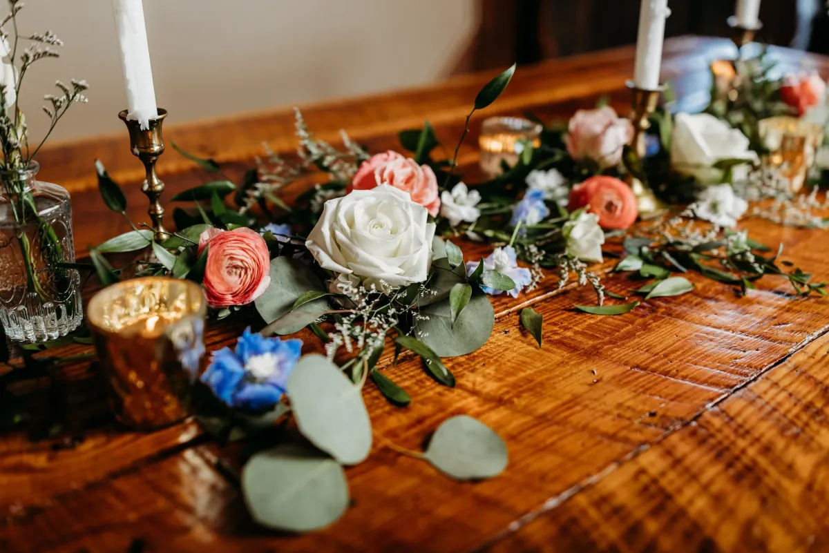 Romantic table garland with roses, candles, and greenery